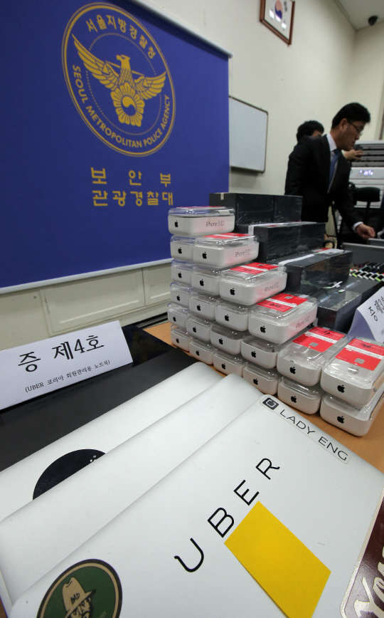 서울지방경찰청 관광경찰대는 우버테크놀로지 설립자 겸 대표인 미국인 트래비스 코델 칼라닉 씨와 우버코리아테크놀로지 한국지사장 강모 씨, 총괄팀장 이모 씨, 국내 법인 우버코리아테크놀로지를 여객자동차운수사업법 위반 혐의로 불구속 입건했다고 17일 밝혔다. 경찰에 따르면 이들은 법인 설립 직후인 2013년 8월부터 최근까지 스마트폰 '우버앱'을 통해 모집한 자가용·렌터카 운전자와 승객을 연결해주고 불법 운송 요금을 챙긴 혐의를 받고 있다. 사진은 이날 서울 중구 북창치안센터에서 공개된 압수 증거품들.  사진=연합뉴스